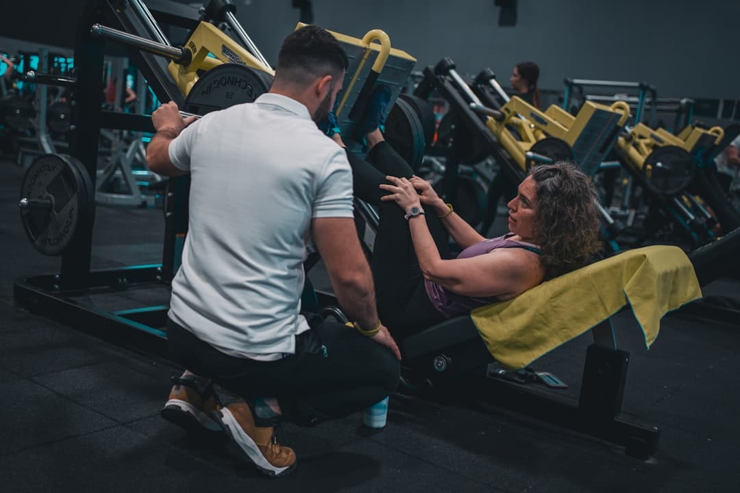 A coach correcting technique at Pulse Performance Gym